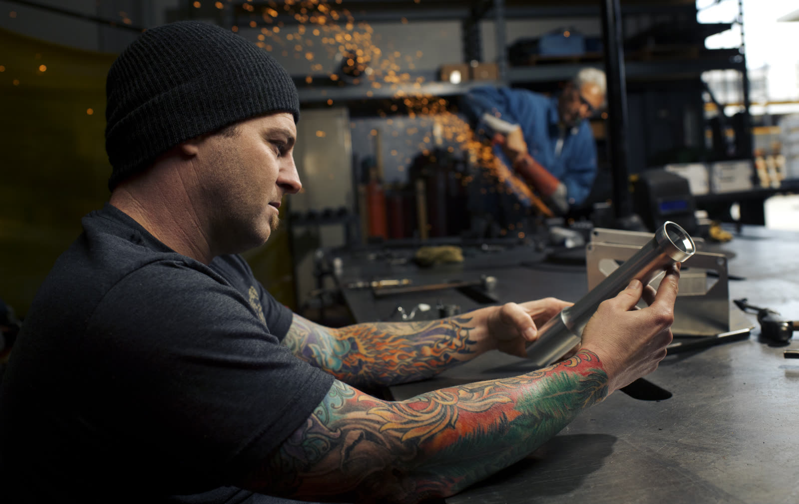 Fabricator inspecting a frame tube in the Active Force workshop